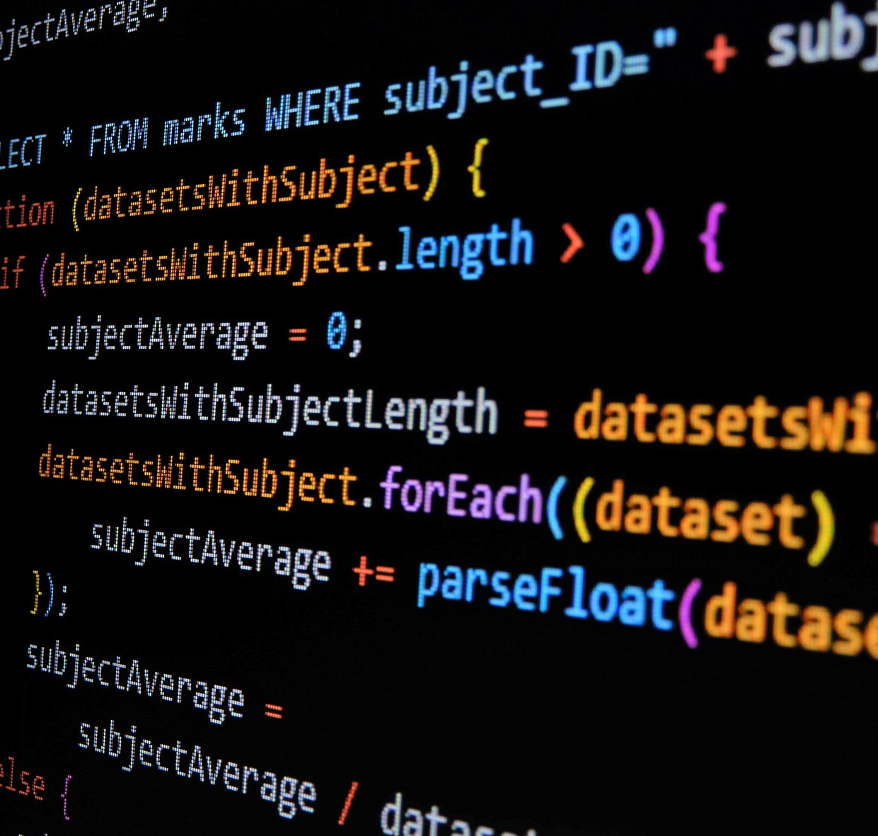 A close-up of colorful programming code on a computer screen, displaying functions and database queries with syntax highlighted in different colors.