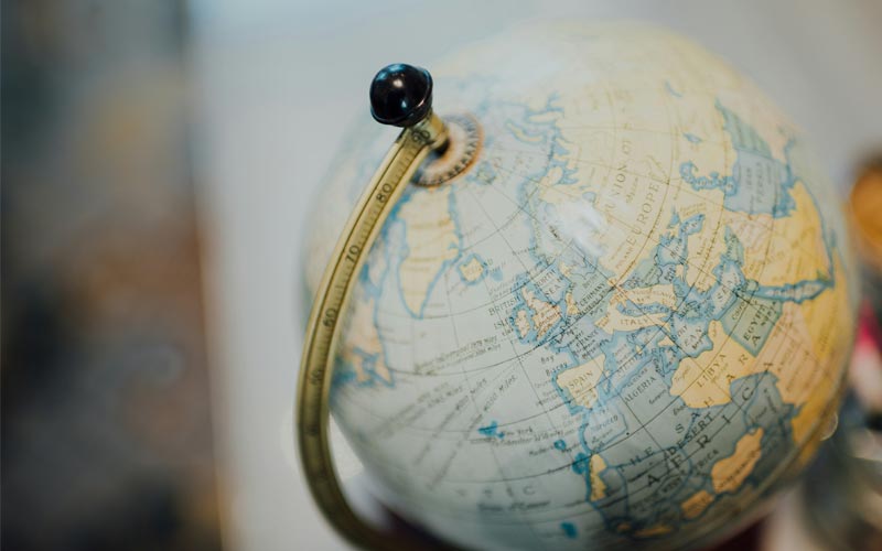 A shot of an old style globe of the Earth with the background blurred.